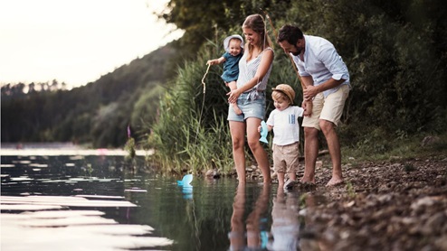family playing in creek