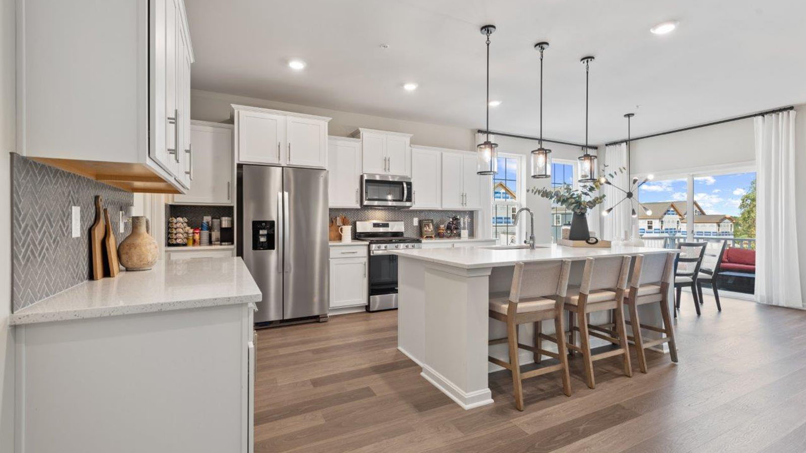 spacious kitchen wiht shaker style cabinets and quartz counters