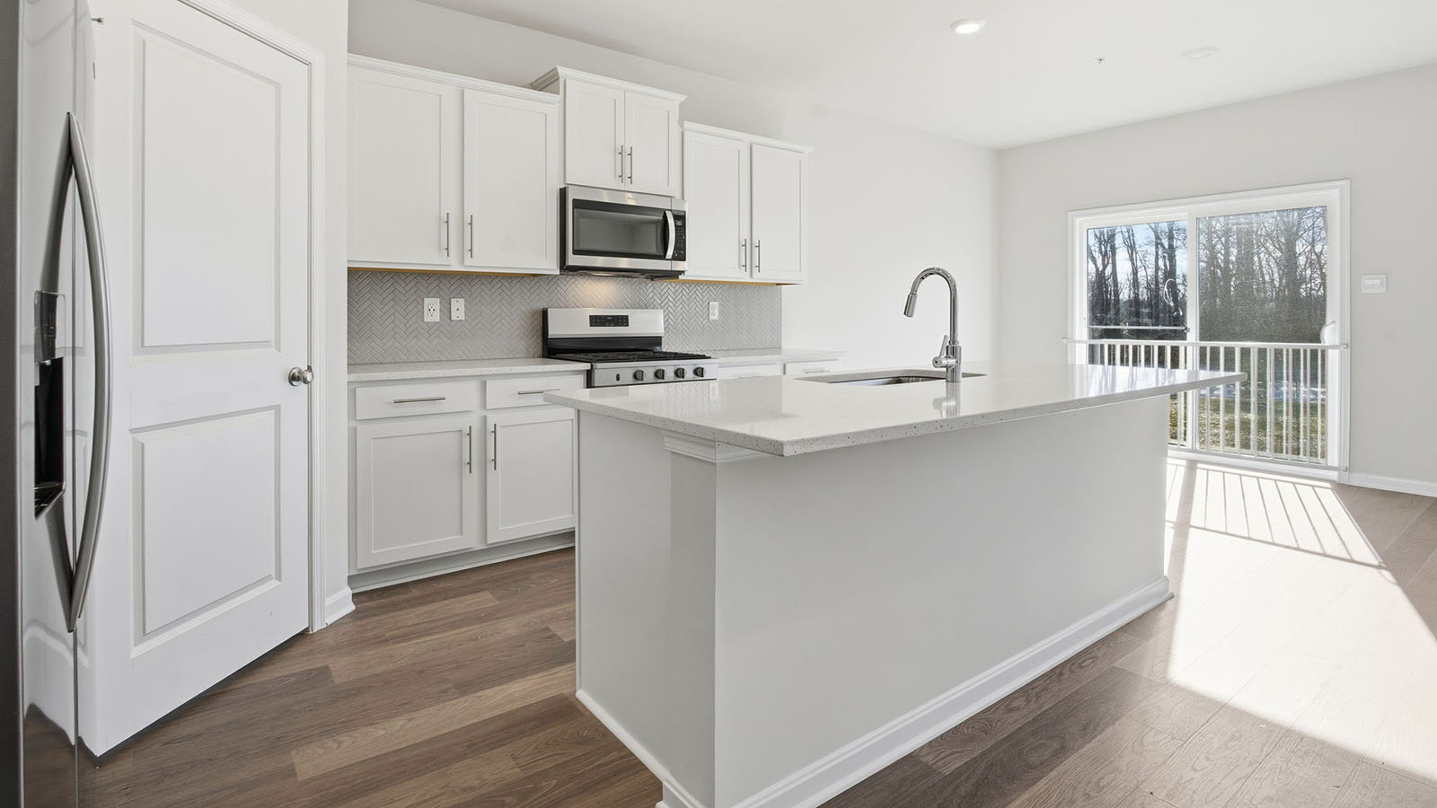 kitchen with white shaker style cabinets and quartz counters