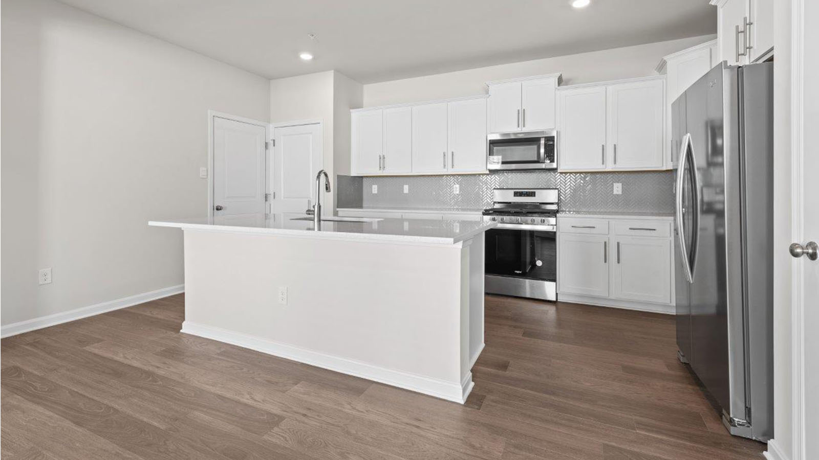 central island with seating and recessed lights