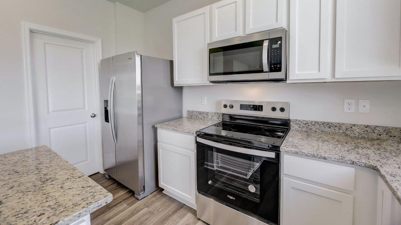 white shaker style cabinets and granite counters