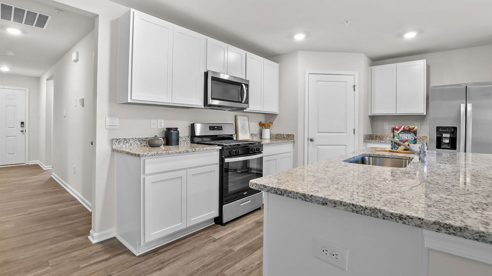 white shaker style kitchen cabinets and granite counters