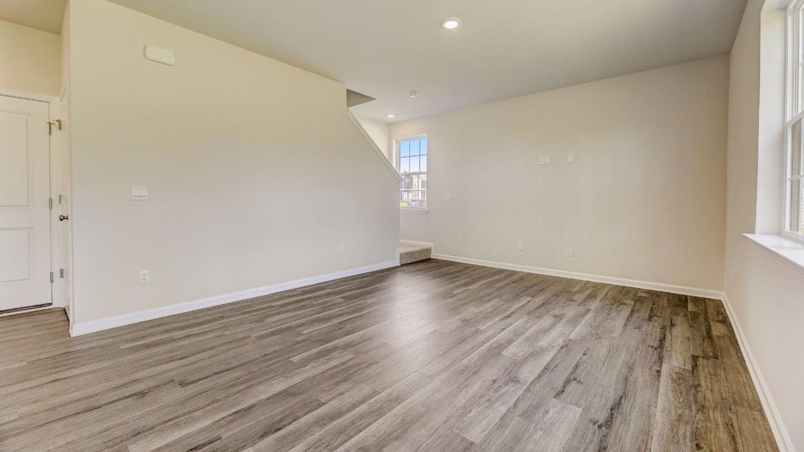 open concept living room with luxury vinyl plank flooring