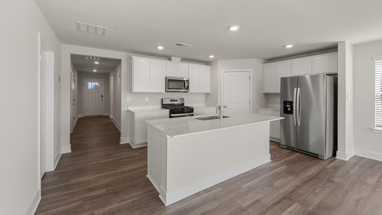 spacious kitchen with central island and corner pantry