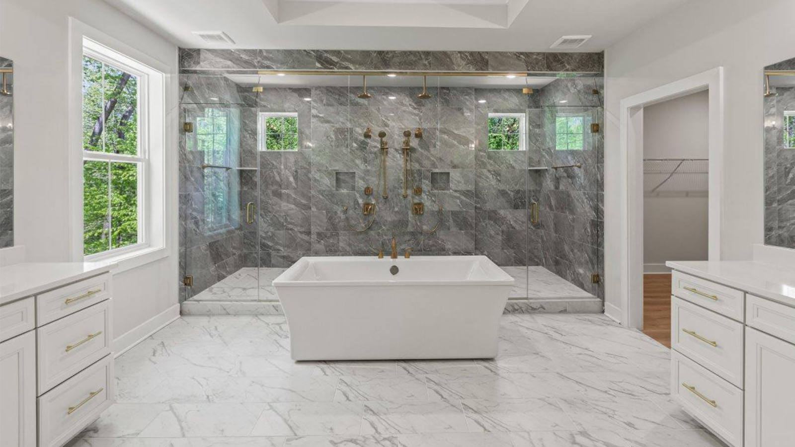 master bathroom with central soaking tub and large glass shower