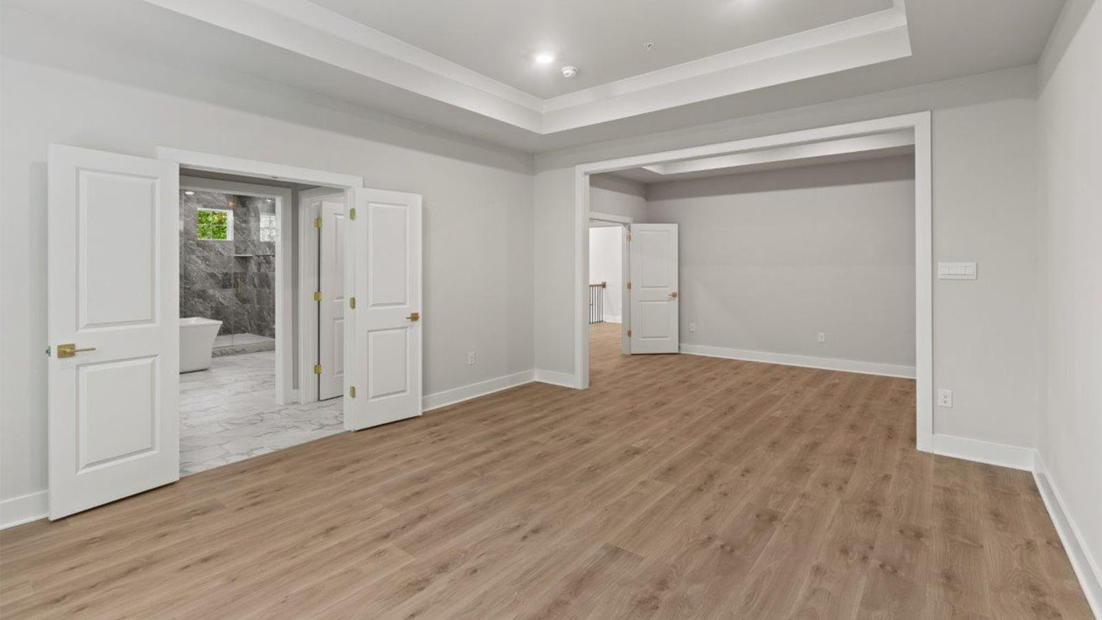 upstairs master bedroom hard surface flooring and tray ceiling