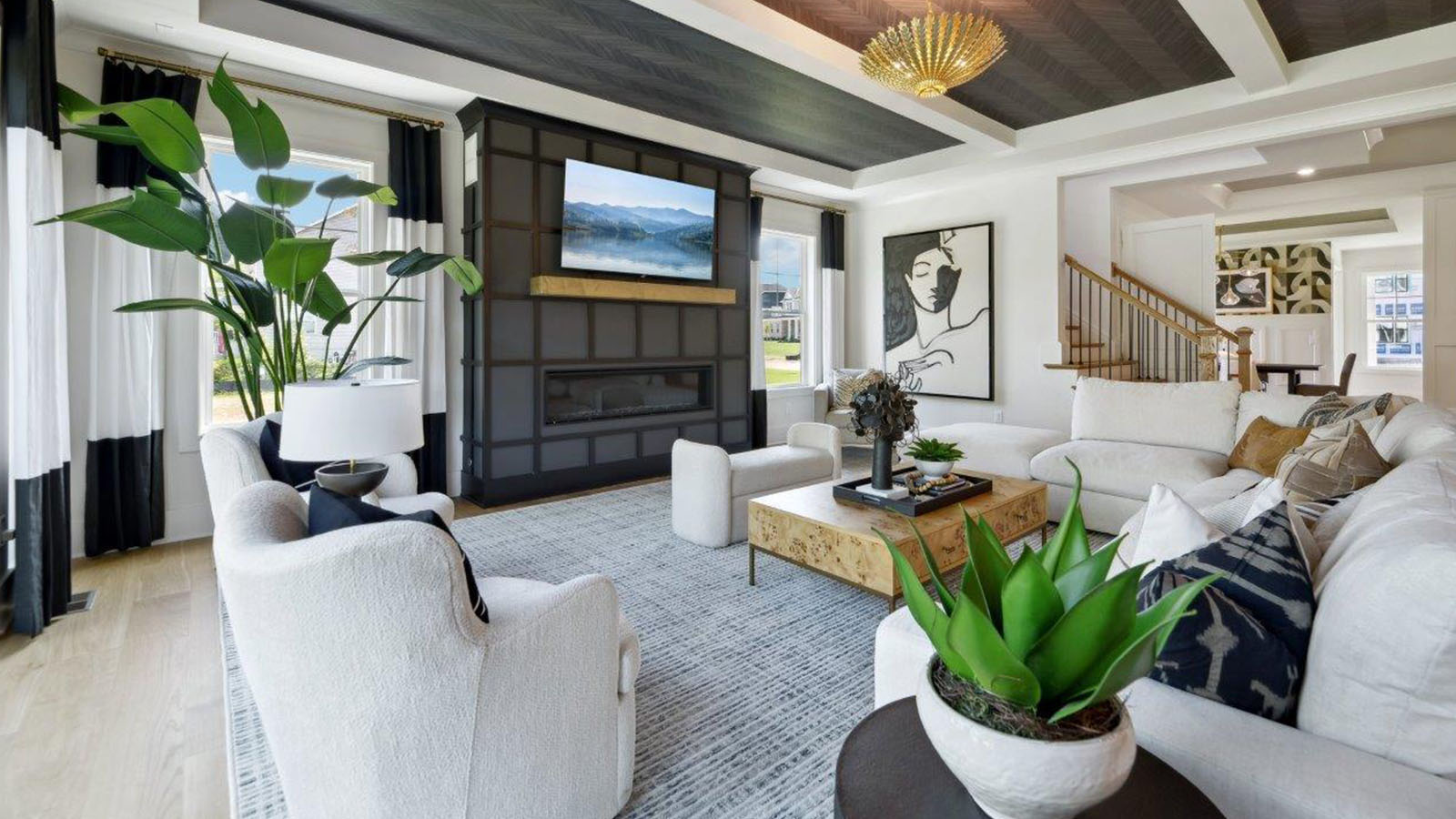 open concept living room with tray ceiling