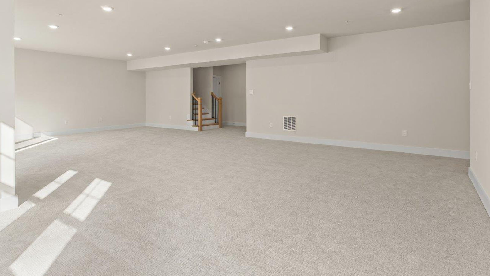 finished basement rec room with large windows and back door access