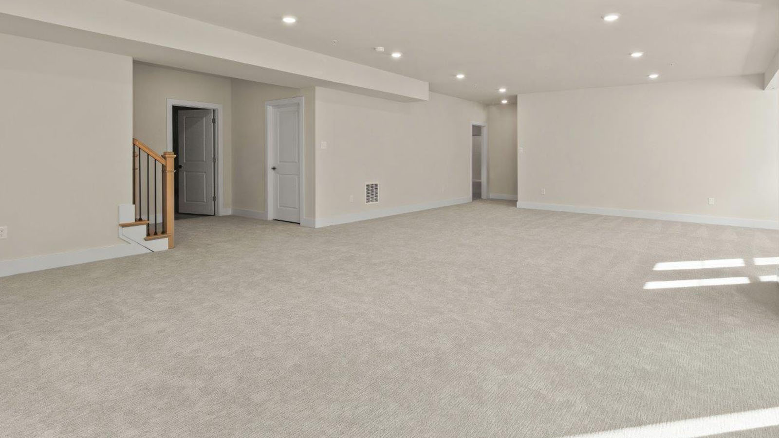 finished basement rec room with large windows and back door access