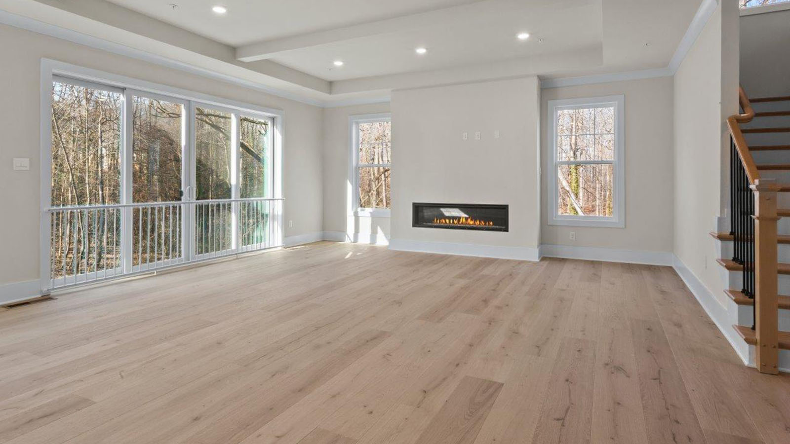 open concept living room with linear fireplace