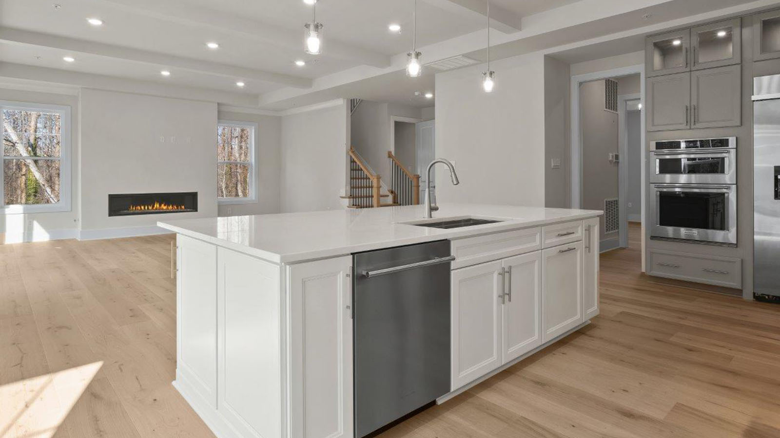 central island with dishwasher, sink and seating