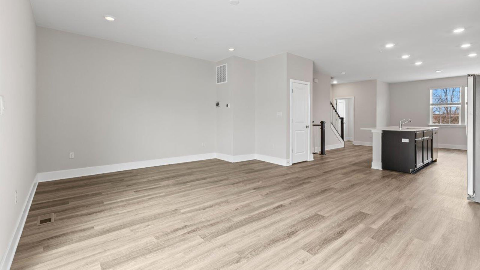 open concept living room with luxury vinyl plank floors