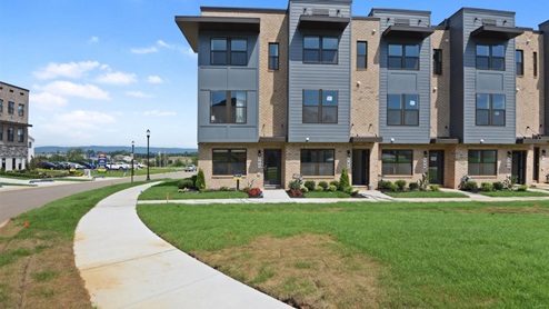 front of three story flat roof townhome