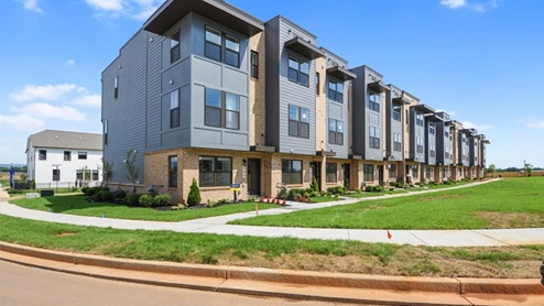 front of three story flat roof townhome