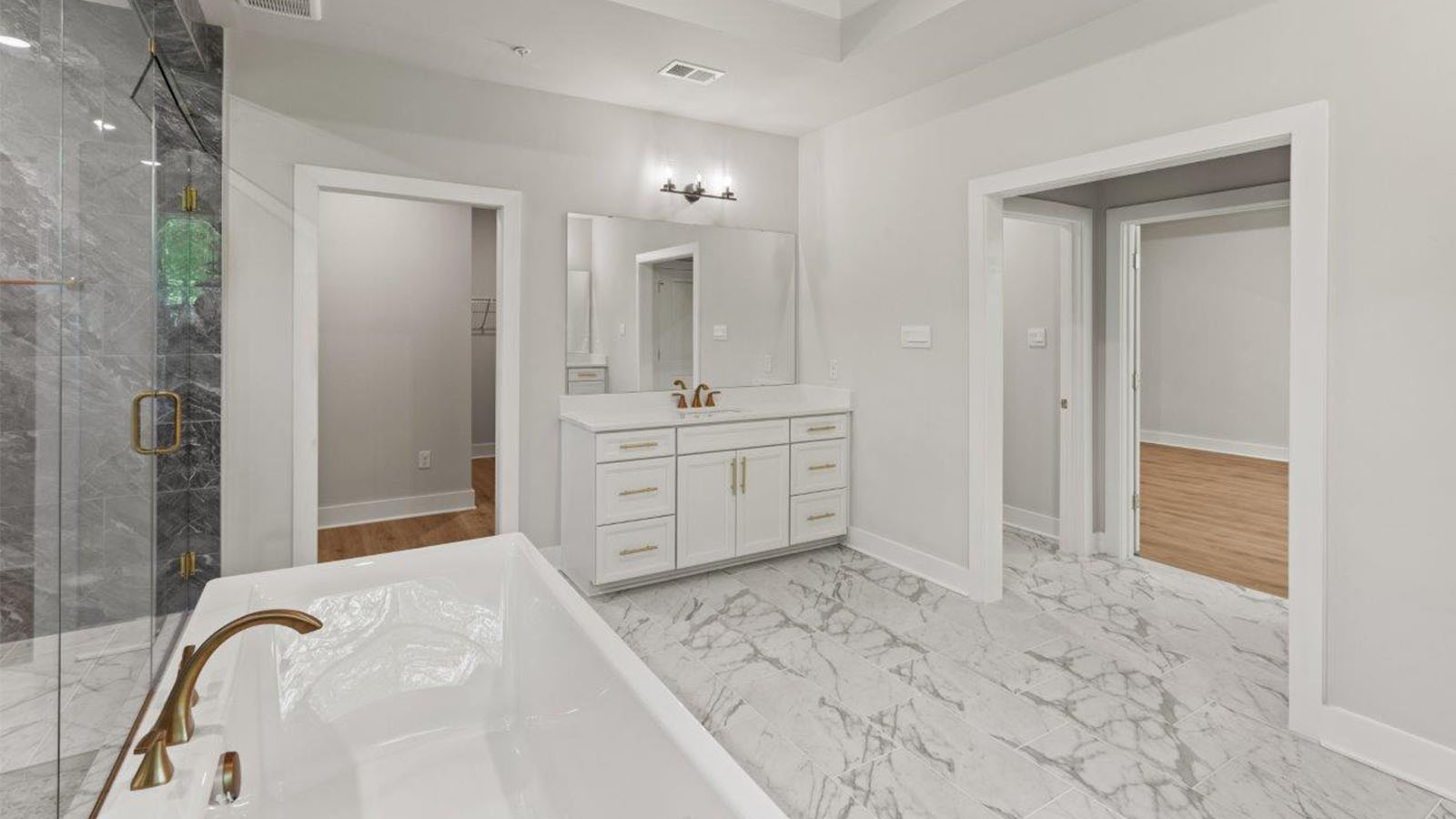 master bath with central soaking tub and large shower