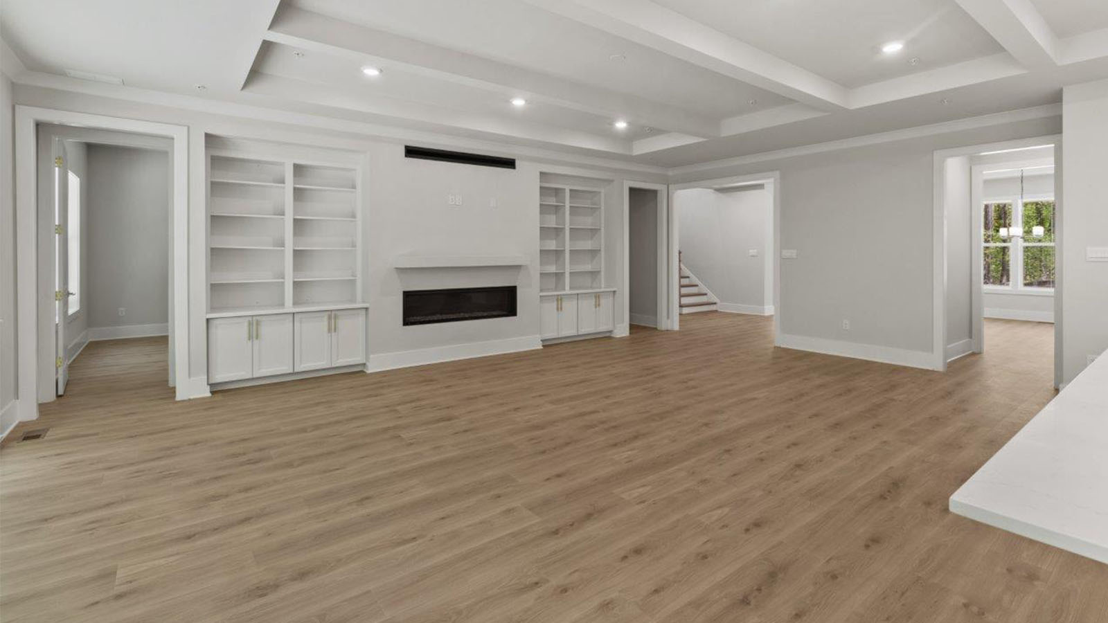 open concept living room with linear fireplace