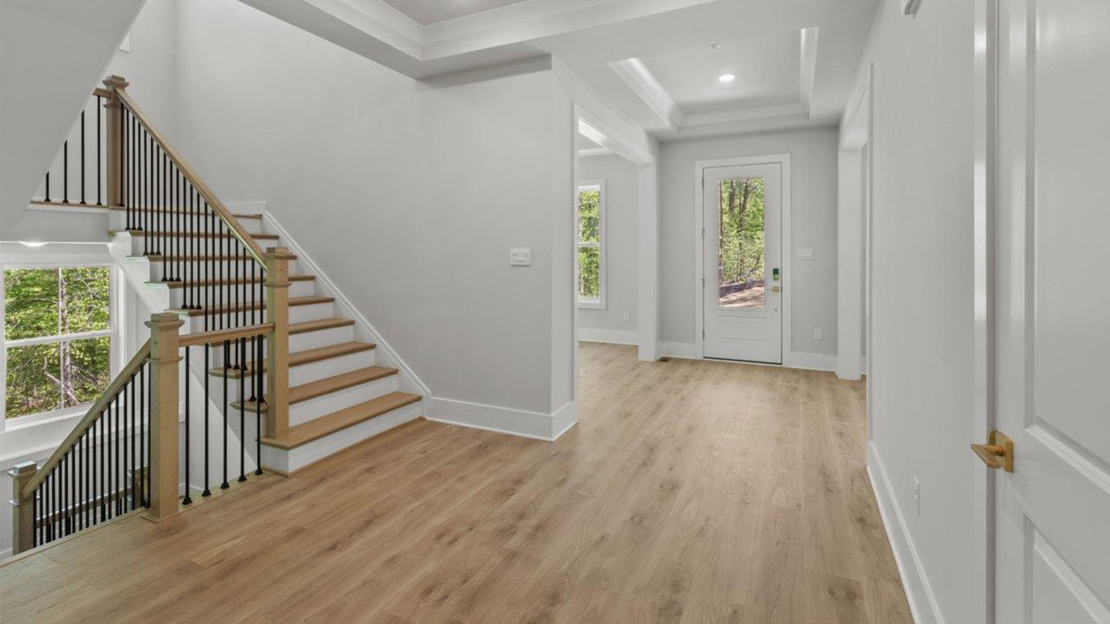 front door leading into living area and kitchen