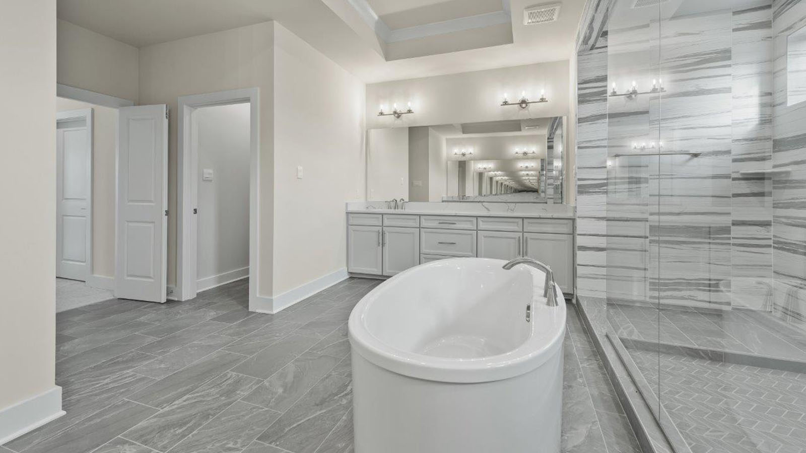 tub in front of large glass shower