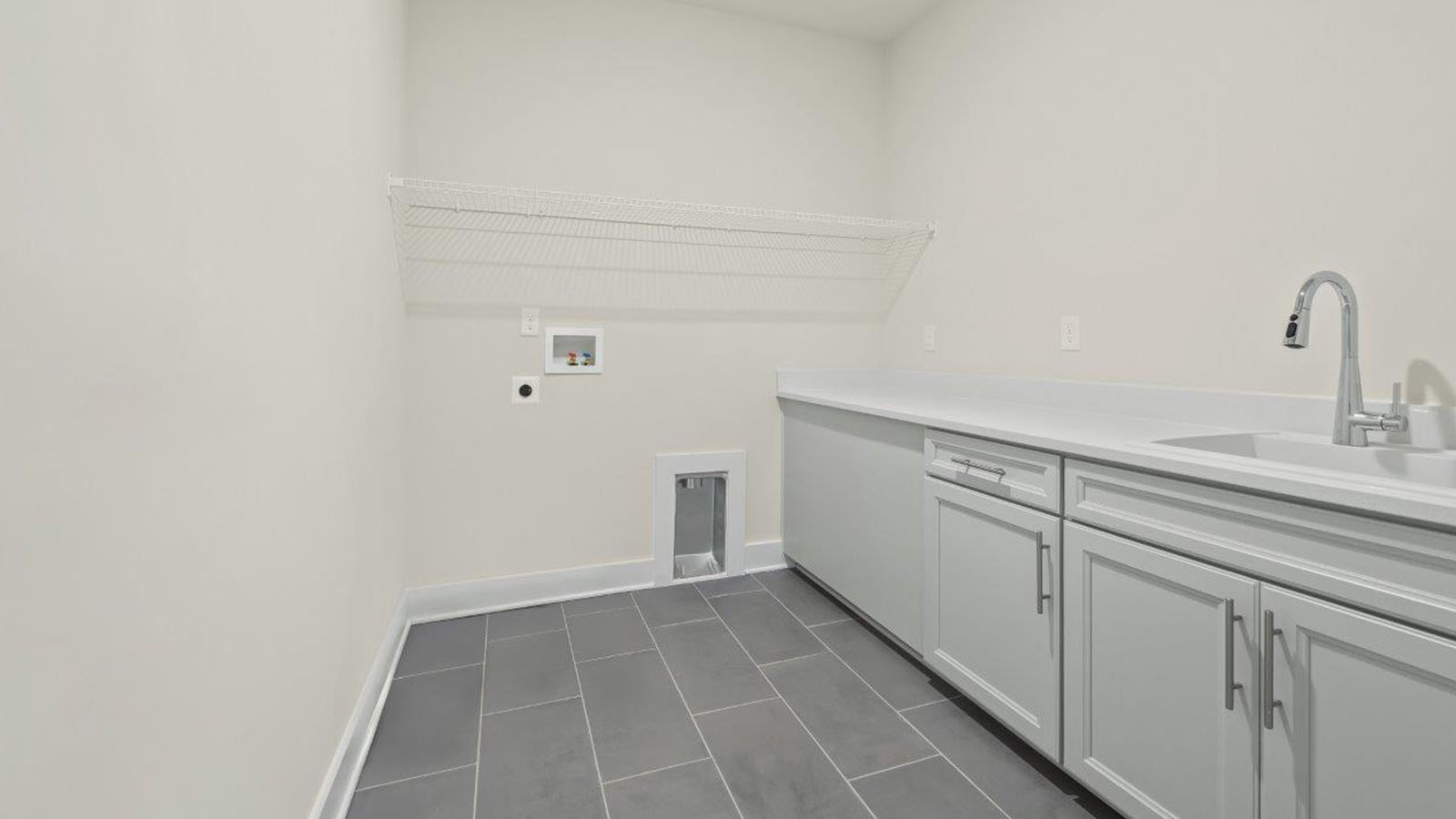 laundry room with folding area and sink