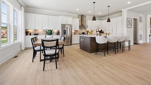 spacious center island with seating and kitchen table