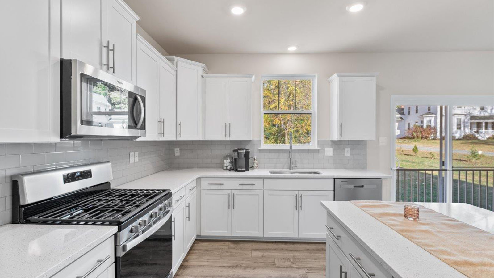 white shaker kitchen cabinets with stainless steel appliances