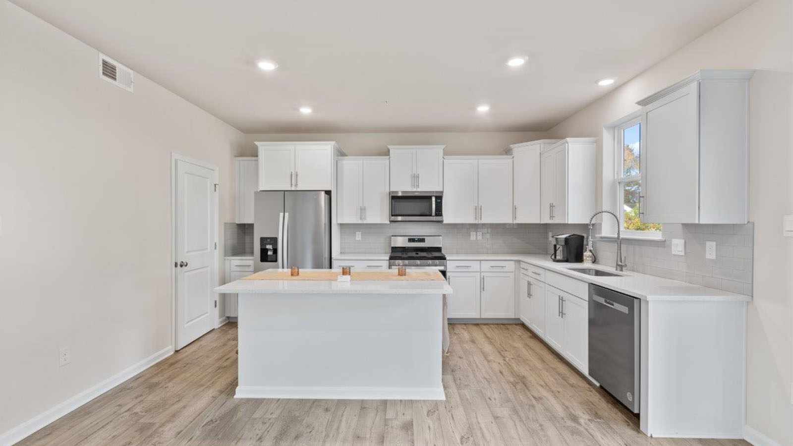 stainless steel appliances and seating at island