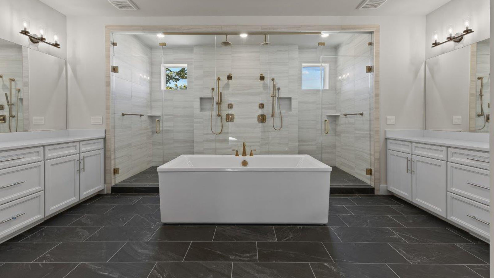 master bathroom with central soaking tub and large glass shower