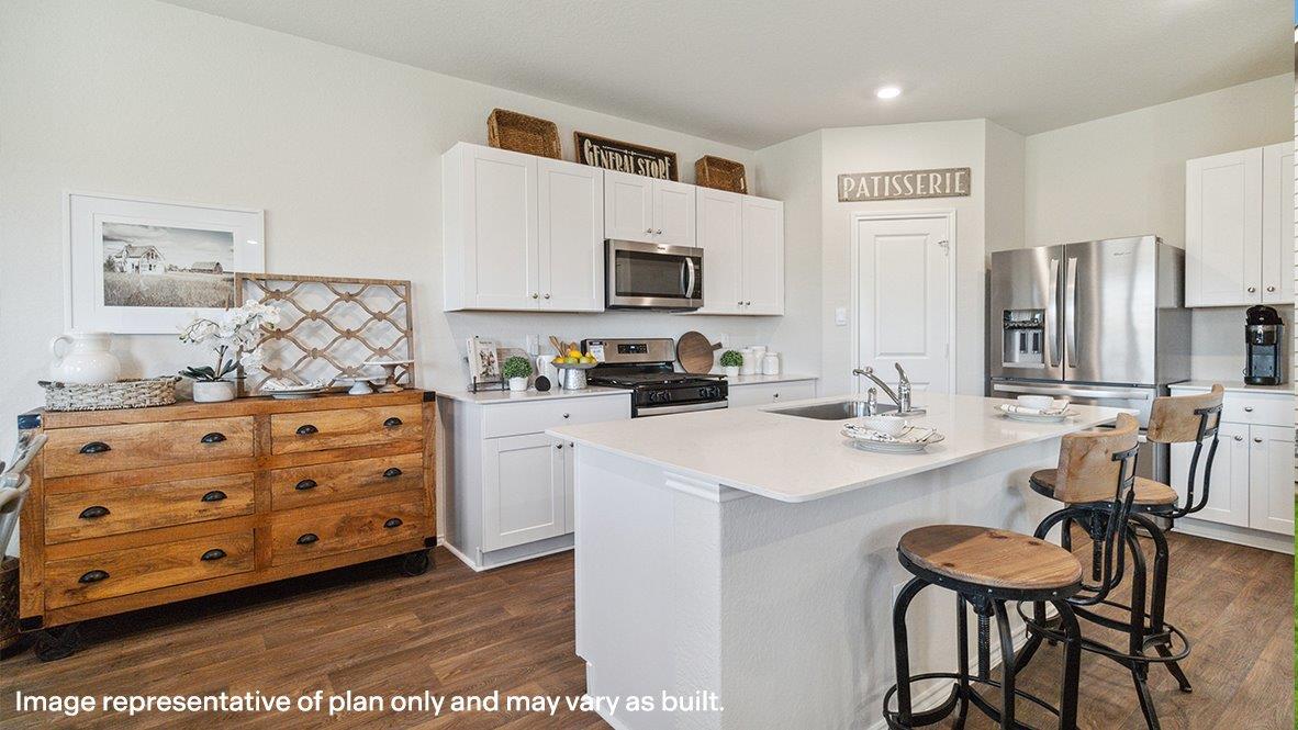 Spacious, open-concept kitchen with island, shaker style cabinets and granite or quartz countertops.