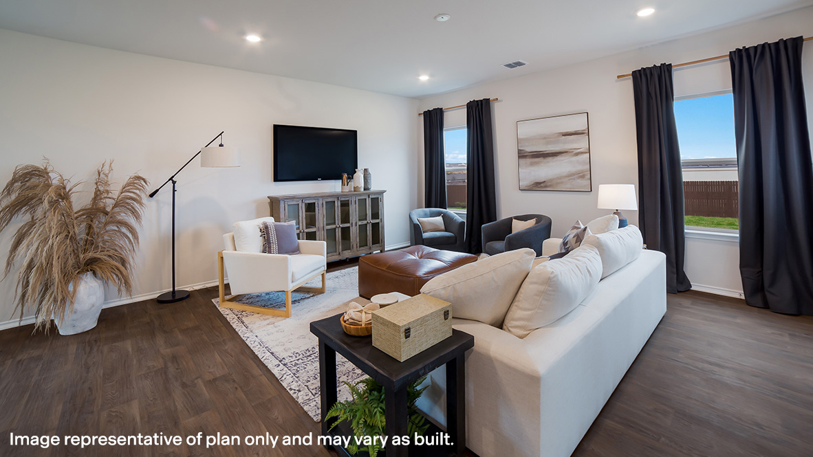 Spacious living area with large windows and hard surface flooring