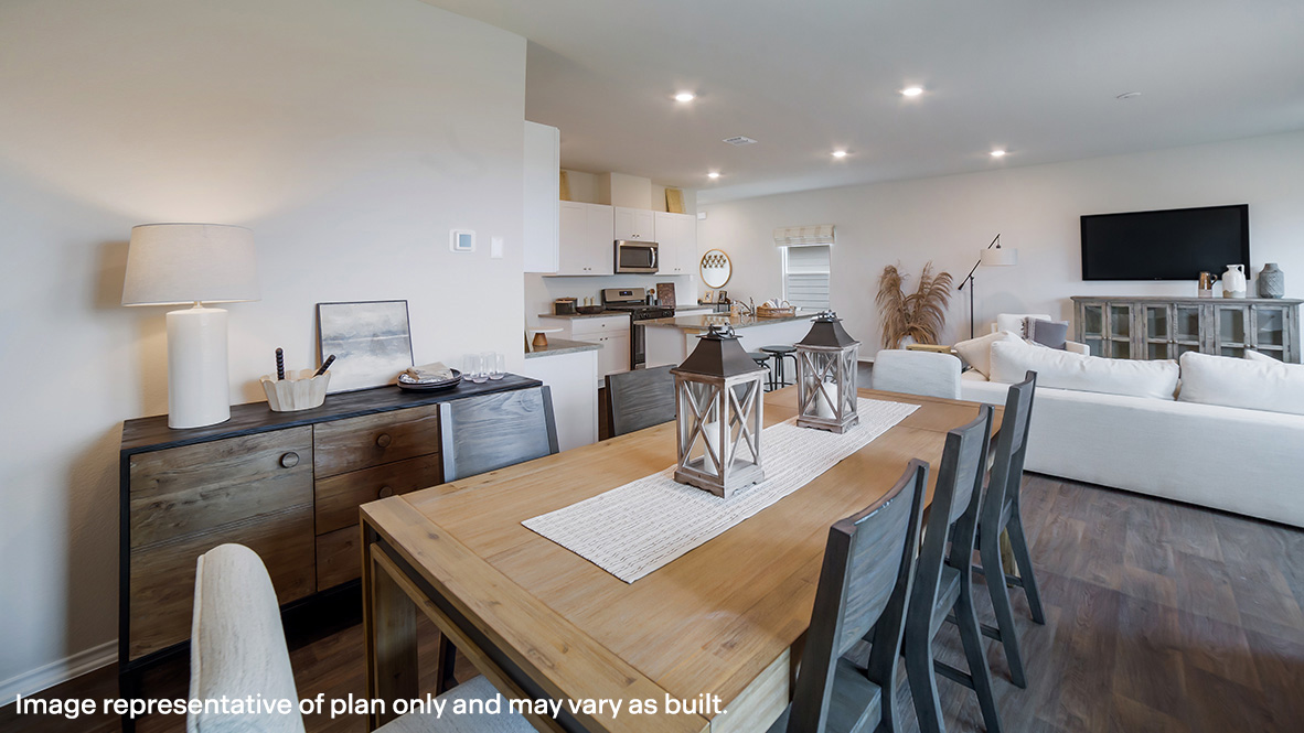 Spacious dining area facing window and overlooking living area.