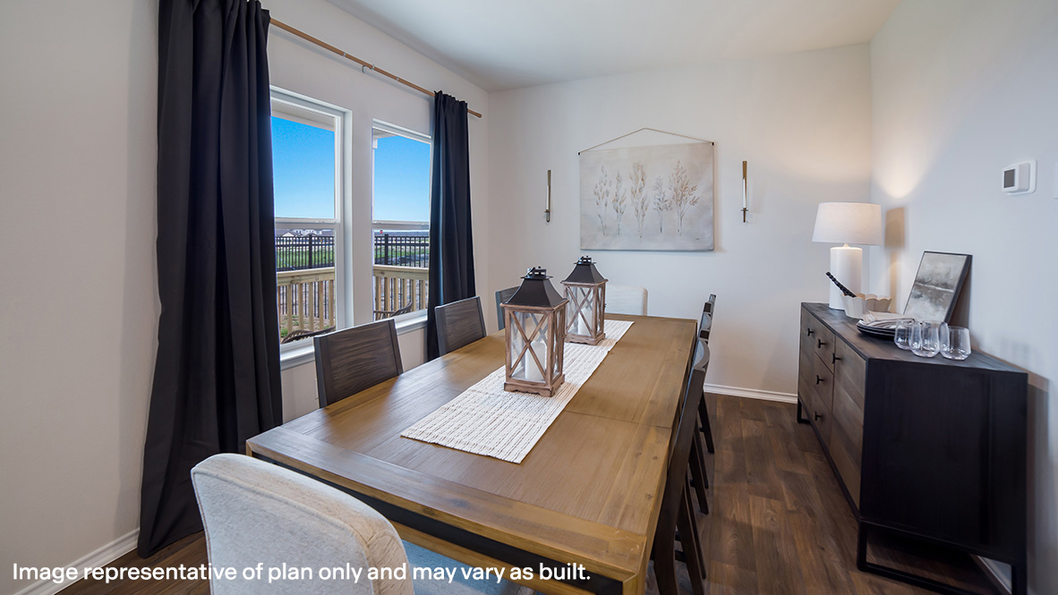 Open-concept dining area with hard surface flooring and large windows.