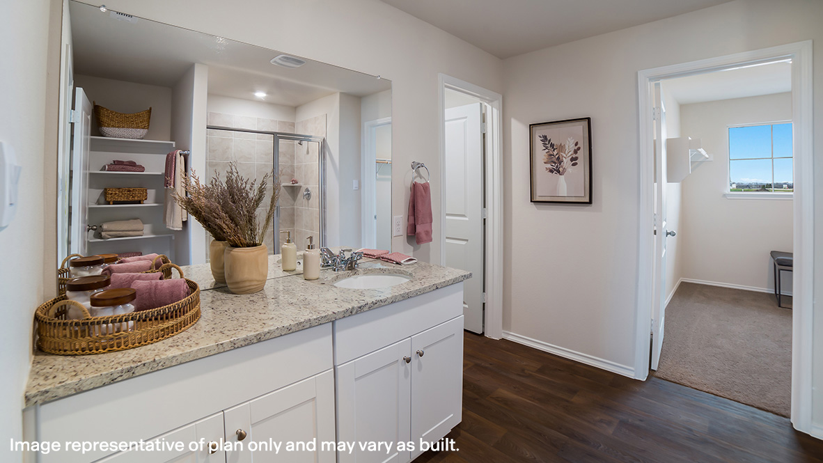 Spacious primary bathroom with plenty of counterspace, single vanity sink and hard surface flooring.