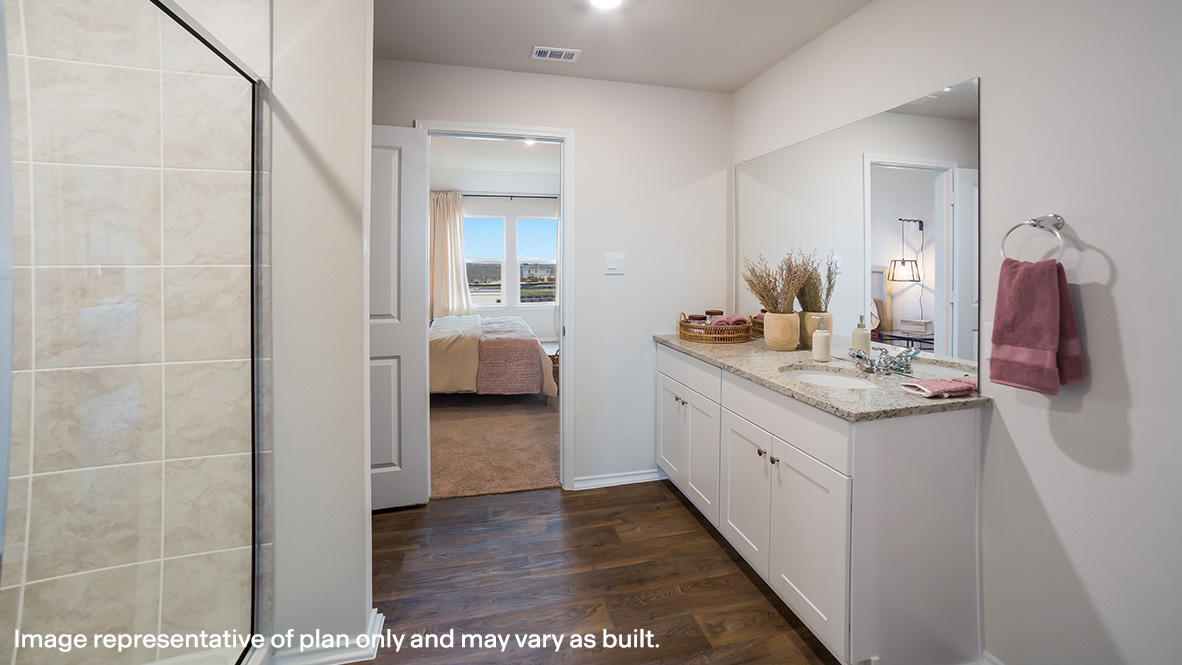 Spacious primary bathroom with walk-in shower and grand walk-in closet.
