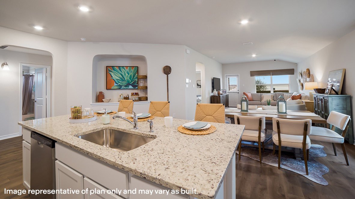 spacious kitchen island with deep farmhouse style sink overlooking open concept dining area and living room