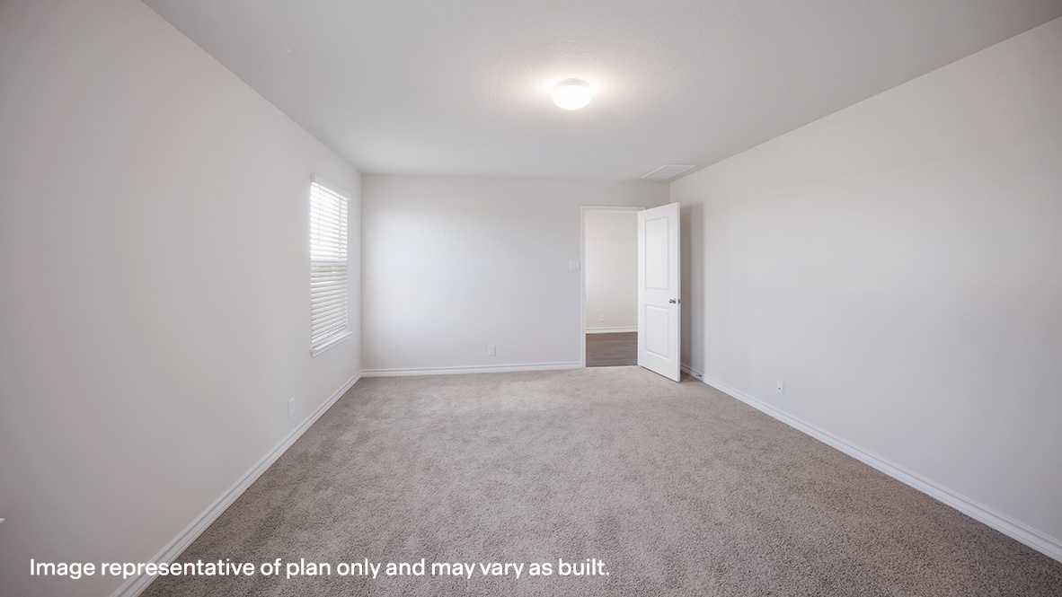 Spacious primary bedroom located at back of house featuring large ensuite bathroom.