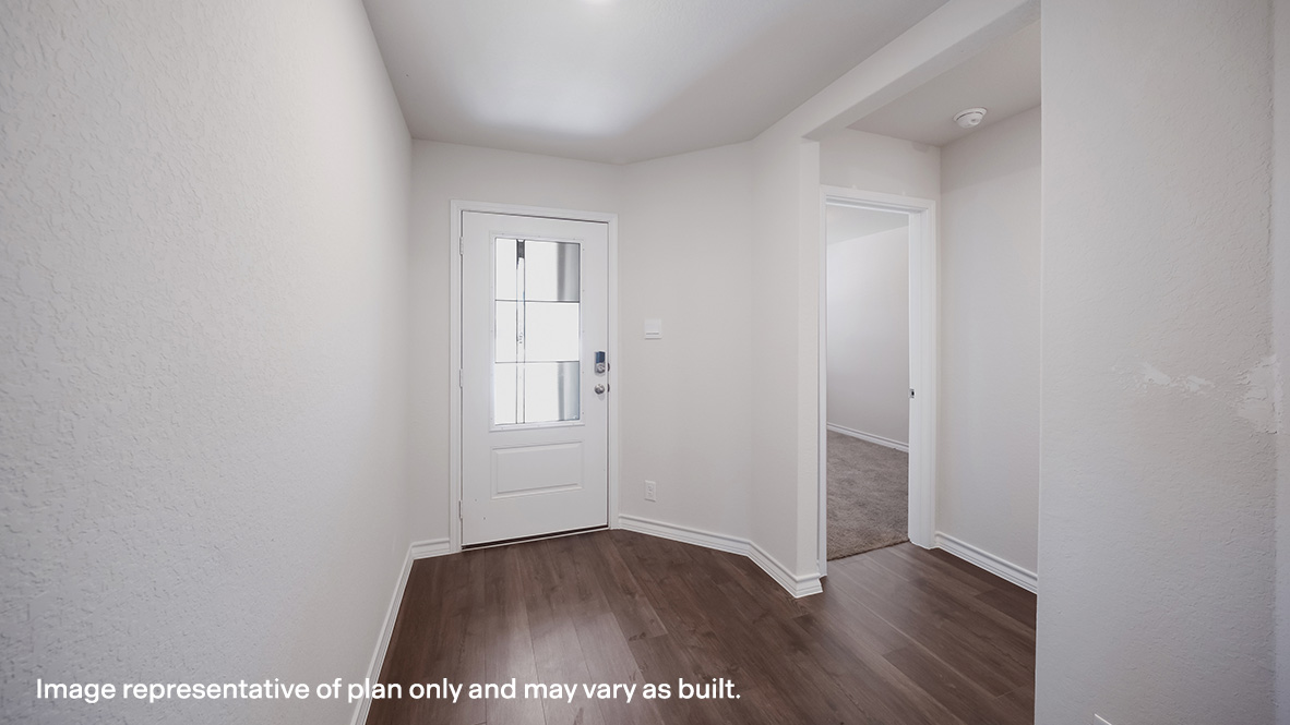 Entryway leading into decorative wall nook and open-concept family area.