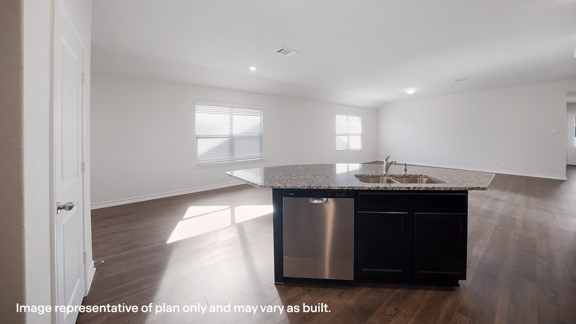 Open-concept kitchen with stainless steel appliances and classic white subway tile backsplash.