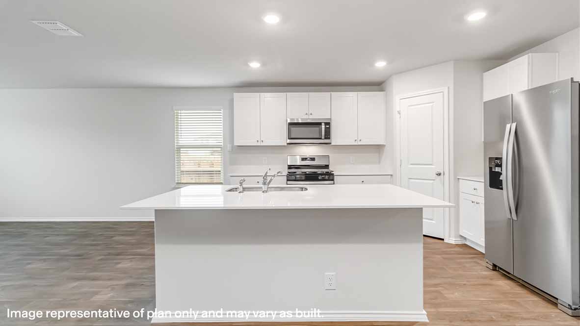 Kitchen with an island, white cabinetry, and stainless-steel appliances