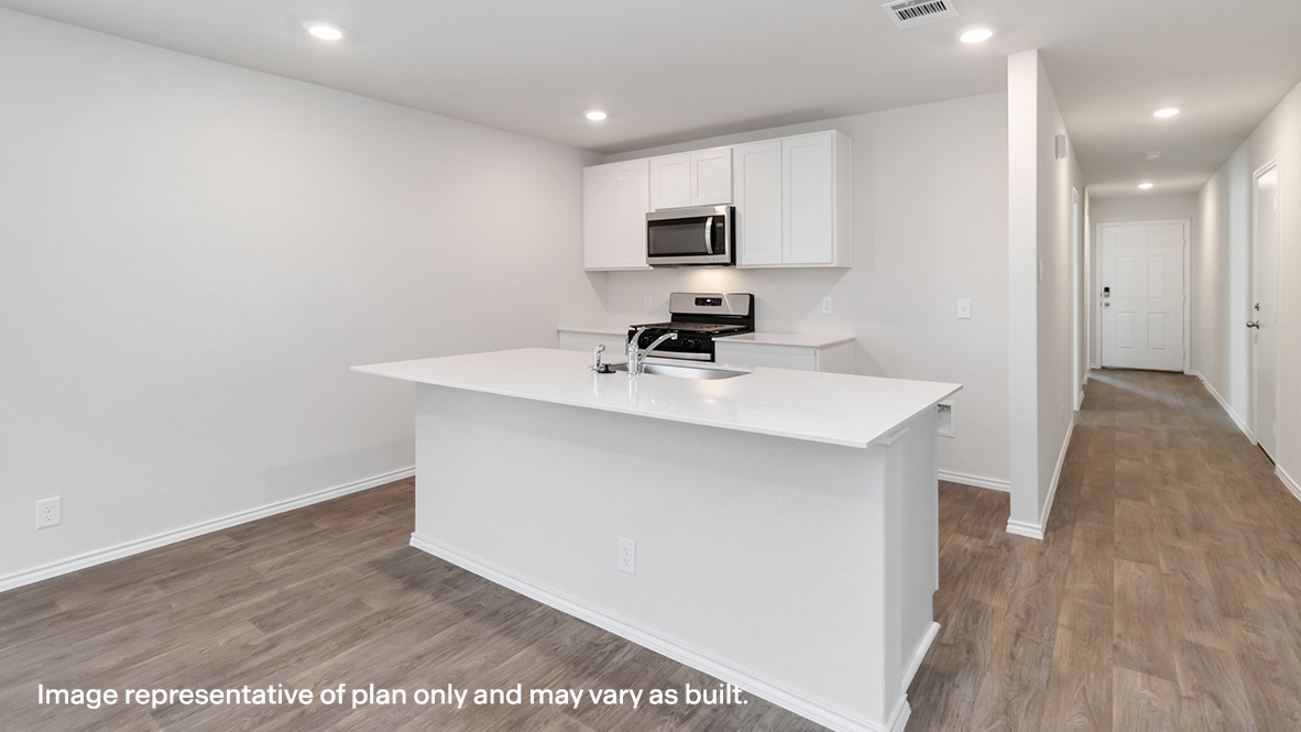 entry hallway leading to kitchen with spacious island and stainless steel appliances.