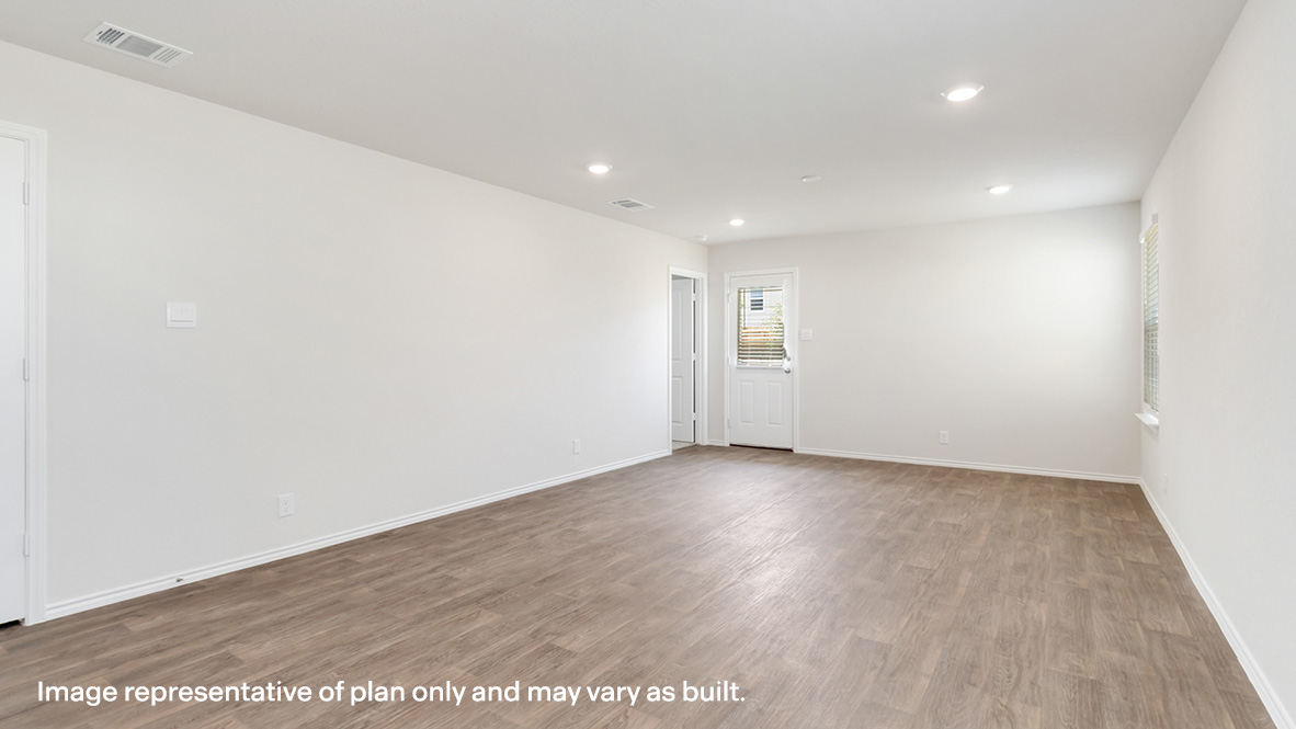 Open concept dining and living room with hard surface flooring throughout.