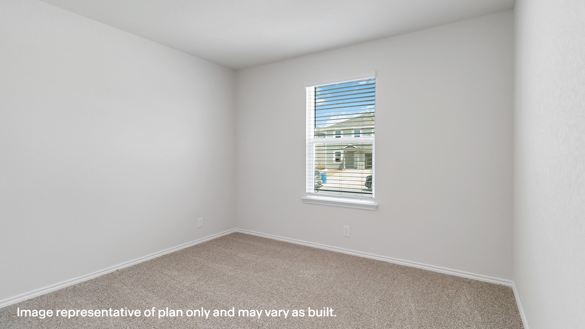 Secondary bedroom with carpet flooring and window.