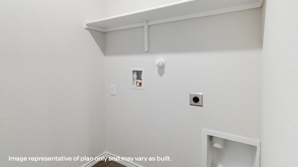 Utility room with built-in shelving, hard surface flooring and washer and dryer connections.
