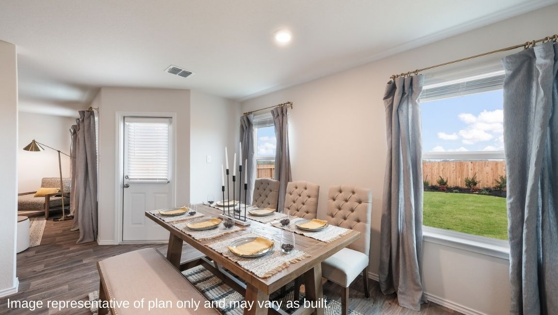 Spacious dining area with hard surface flooring and windows providing plenty of natural light.