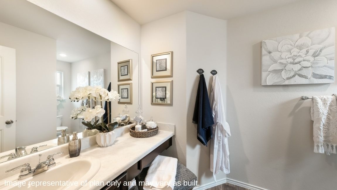 Spacious bathroom with single vanity sink, hard surface flooring and plenty of counterspace.