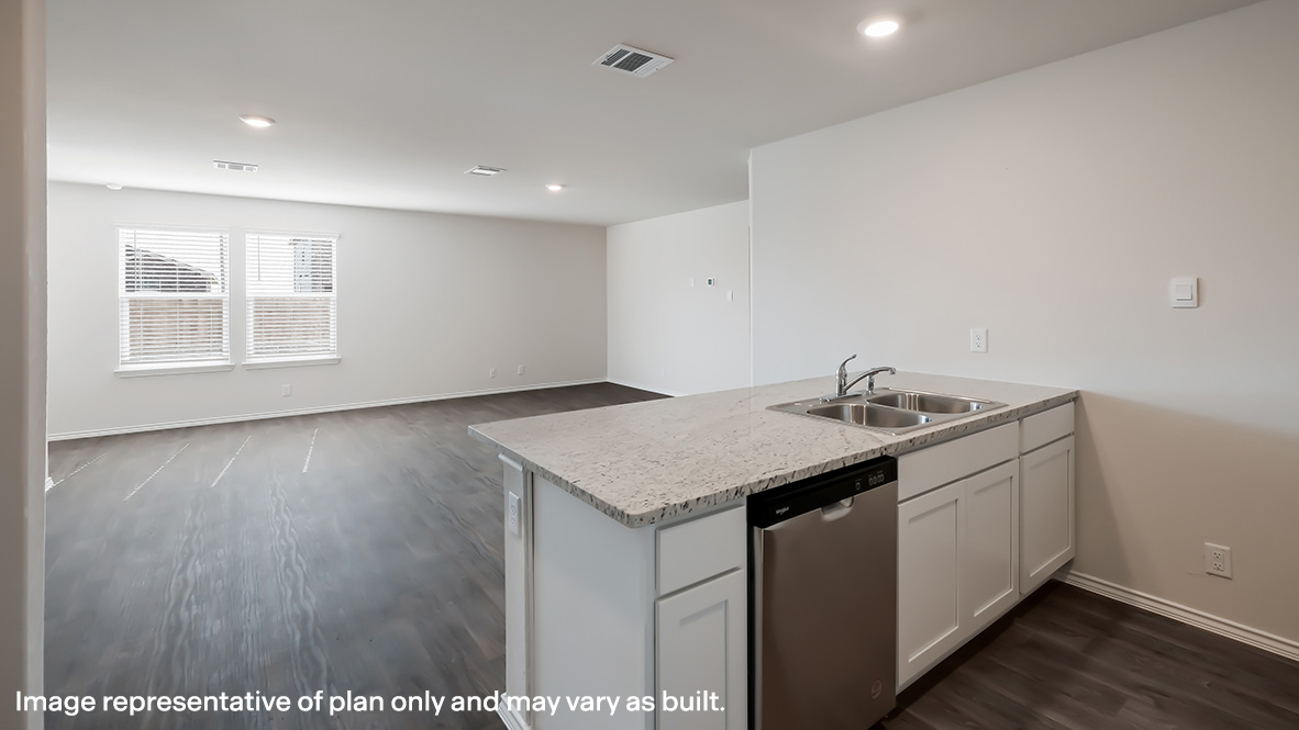 Spacious kitchen island with quartz or quartz countertops and stainless steel dish washer overlooking the open concept living room and dining area.