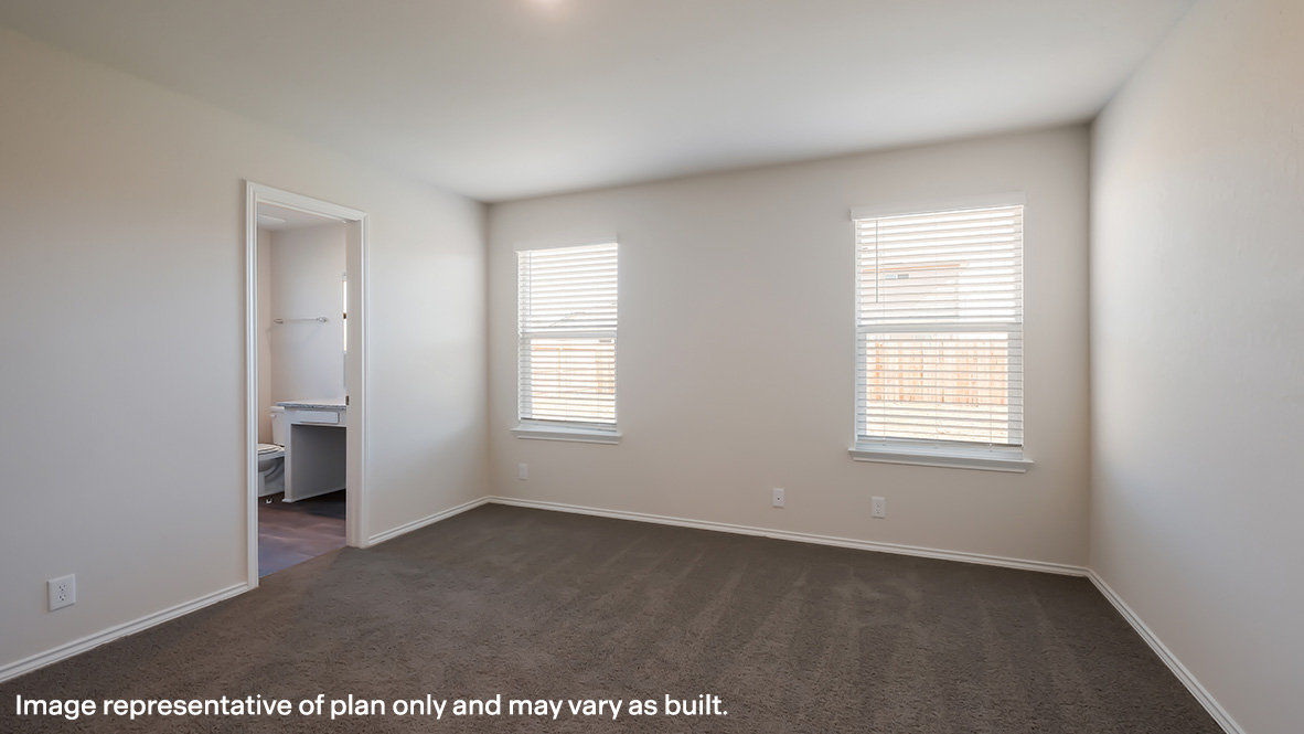 Spacious primary bedroom with ensuite bathroom, quality carpet flooring and large windows.