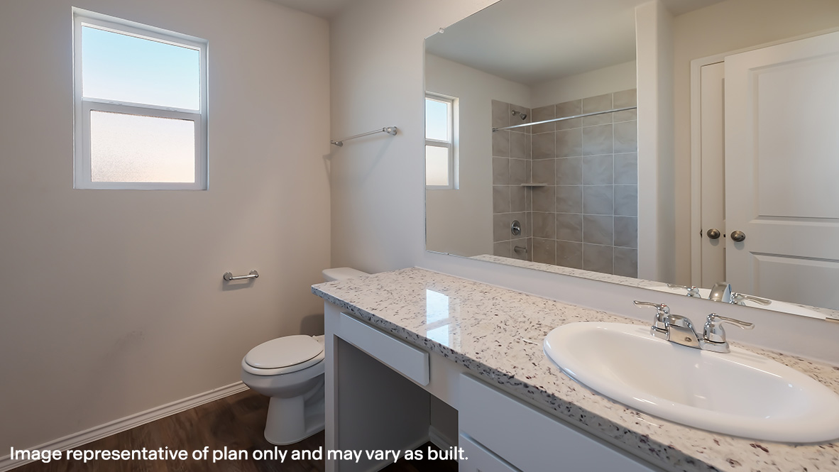 Main ensuite bathroom with toilet, single vanity sink and combined tub and shower.
