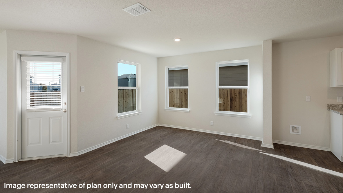 Dining area with large windows providing lots of natural light and door leading to backyard.