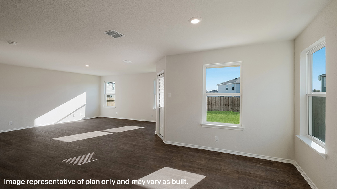Combined living and dining area with hard surface flooring and plenty of windows.