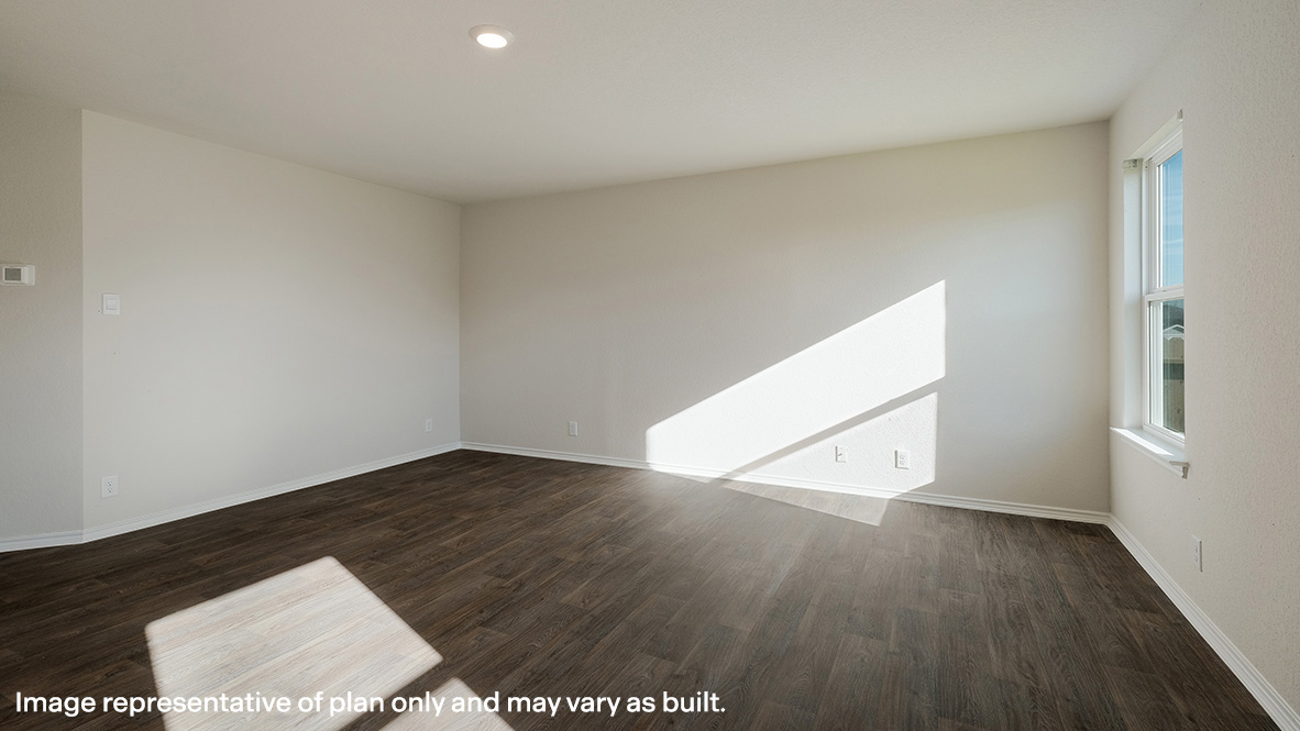 Living room with hard surface flooring and large windows.